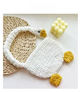 Detail of handmade crochet white goose bag showing woven texture and cute design