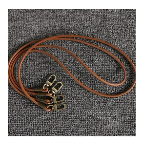 Detail of brown leather cords with vintage bronze lobster clasps for handmade crafts