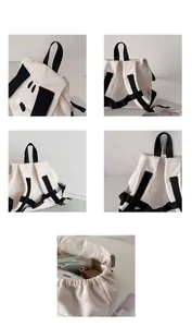 Detailed interior of a cartoon puppy canvas backpack showing diapers and a water bottle