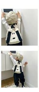 Detail view of the cute cartoon dog pattern on a beige canvas toddler backpack