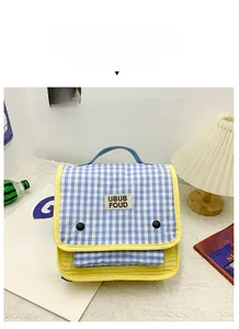 Close-up of blue gingham canvas kids backpack with yellow piping and UBUB label