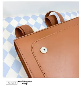 Macro shot of the caramel brown PU leather bag featuring a magnetic metal hardware closure