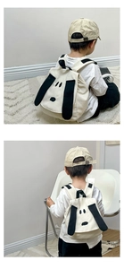 Detail shot of a cute cartoon dog puppy canvas toddler backpack with long black ears
