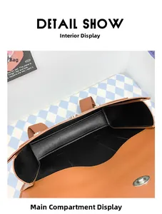 Detail view of the brown leather backpack interior with magnetic buckle and black lining