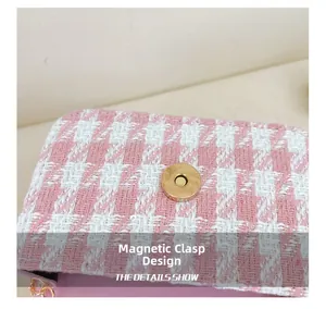 Detail view of pink and white tweed bag showing the secure golden magnetic snap closure