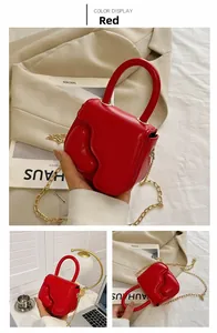 Detail of red mini square bag with heart texture, gold chain and stylish handle