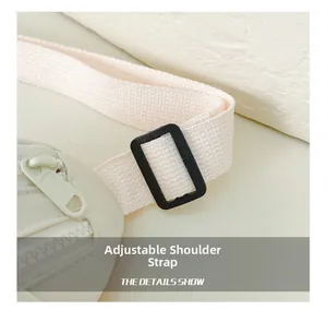 Detail showing the adjustable woven shoulder strap and sturdy black plastic buckle