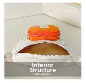 Detail of children's waist bag showing the spacious inner compartment and contrast colors