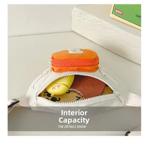 Detail view showing interior capacity of kids chest bag with small power bank and mirror