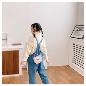 Girl's pink plaid flower handbag styled with denim overalls and knit sweater