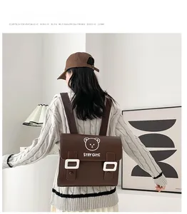 Rear view of brown PU leather kids backpack with bear head and STAY CUTE slogan