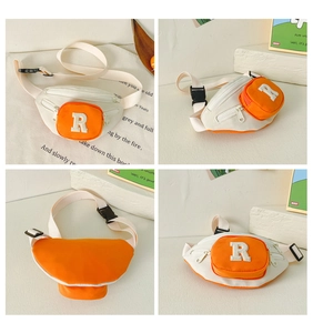 Detail view of children's waist bag with orange contrast pocket and R letter patch