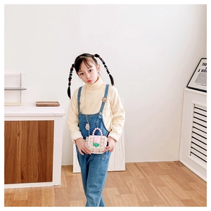 Pink plaid mini handbag with pearl handle and tulip decoration on a child model
