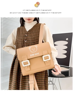 Detail of cute bear pattern and 'STAY CUTE' text on stylish PU leather school bag