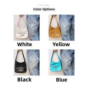 Detail view of canvas crossbody bags in four colors with long straps and front pockets
