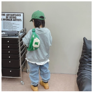 Kids green crossbody chest bag featuring a white pocket with 'R' logo and adjustable strap