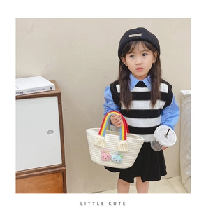Détail du mini panier tissé pour enfant avec anse arc-en-ciel et écussons de lapin