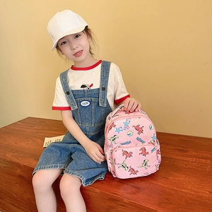 Pink canvas kids backpack with colorful dinosaur prints and front zipper pocket