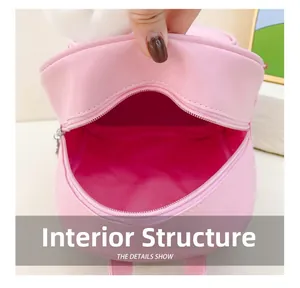 Gros plan sur le compartiment interne et la doublure rose avec détails du zip du sac enfant
