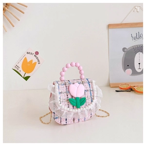 Close-up of girls tweed handbag featuring pearl handle and pink tulip floral detail