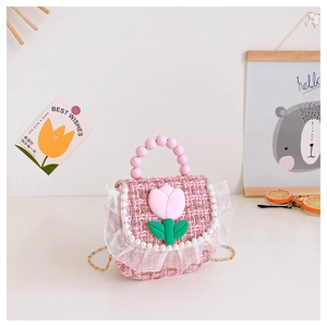 Detail of pink tweed girl's handbag with floral tulip decor and pearl beaded handle