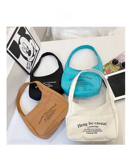 Canvas kids crossbody bags in black, blue, brown, and white colors with front pockets