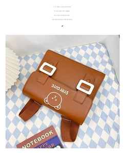 Detail of a brown PU leather kids backpack with a cute bear print and STAY CUTE text
