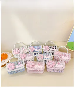 Detailed display of colorful tweed girl purses with faux pearl handles and pink fabric flowers