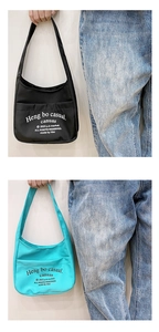 Detail view of canvas hobo bags in black and cyan with stylish letter printing
