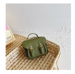 Gros plan sur le mini sac vintage vert foncé en cuir PU avec doubles boucles en métal
