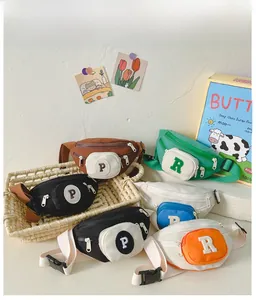 Detailed view of kids' canvas waist bags with adjustable straps and letter patch