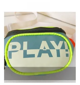 Detail view of children's waist bag with gray-blue color block and PLAY! text print