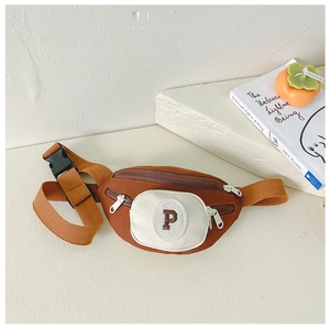 Detailed view of kids' color-block chest bag with letter P embroidery and zip pockets