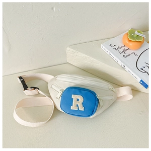 Close-up of kids canvas waist bag with blue zipper pocket and letter R embroidery