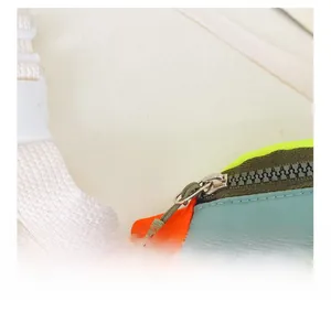 Detail of smooth metal zipper and neon color-block nylon fabric on kids fanny pack