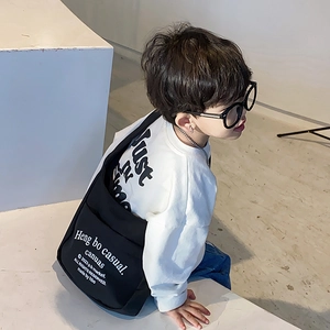 Kids black canvas crossbody bag with white letter print in a casual Japanese style