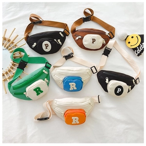Flat lay of colorful children chest bags with letter patches in six different colorways