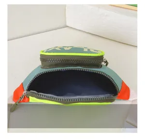 Detail view of multicolored kids crossbody bag showing interior capacity and zipper pouch