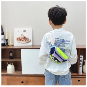 Detailed view of color-block kids crossbody chest bag with adjustable white strap