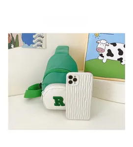Detail of green and white nylon chest bag for boys with letter R embroidery and size reference
