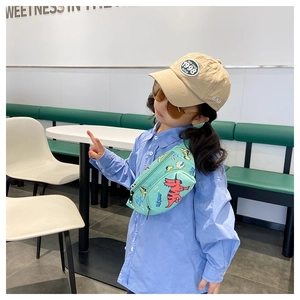 Marsupio in tela verde menta per bambini con stampe di dinosauri su outfit da modello