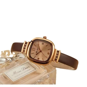 Elegant ladies square watch with gold case and brown leather strap on luxury backdrop