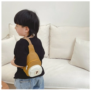Detail of kids nylon crossbody chest bag in yellow and beige with letter P patch embroidery