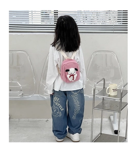 Pink canvas kids backpack with cute plush puppy doll detail on adjustable white straps