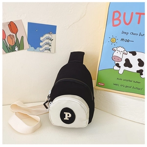 Detail of kids black and white contrast nylon chest bag with round letter P patch