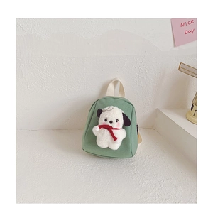 Detail of green canvas mini toddler backpack with 3D plush puppy toy and top handle