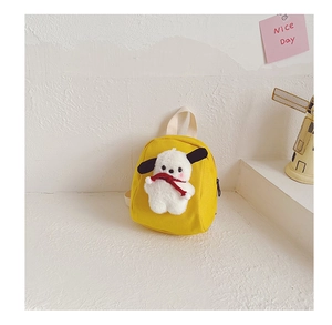 Detail of yellow canvas toddler backpack featuring a 3D plush puppy with red scarf decoration