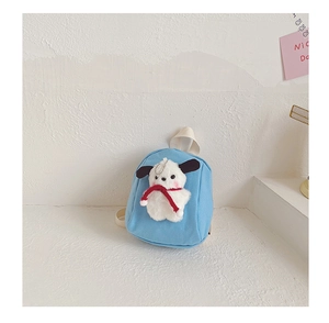 Close-up of light blue canvas toddler backpack featuring 3D plush dog doll detail