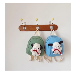 Detail of canvas mini backpacks in light green and blue with cute white plush puppy dolls
