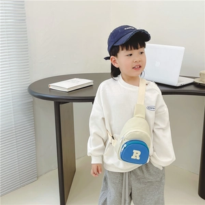 Kids nylon crossbody chest bag with blue round pocket and white letter R patch detail